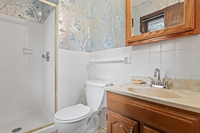 8200 77th St S, Cottage Grove, MN 55016 - bathroom featuring wallpapered walls, a stall shower, vanity, tile walls, and wainscoting