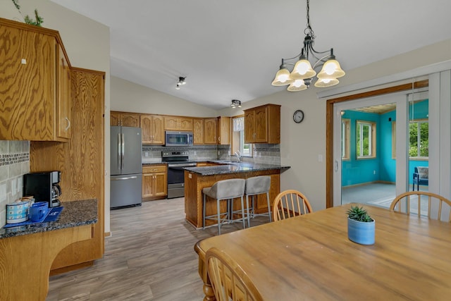 1506 6th Ave N, Sartell, MN 56377 - dining room featuring lofted ceiling, a chandelier, and light wood finished floors