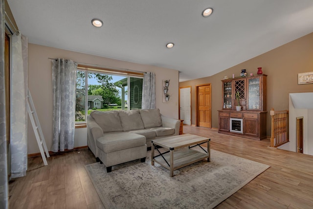 1506 6th Ave N, Sartell, MN 56377 - living area with a bar, light wood-style flooring, vaulted ceiling, and baseboards