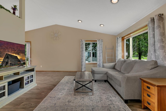 1506 6th Ave N, Sartell, MN 56377 - living room featuring vaulted ceiling, recessed lighting, wood finished floors, and baseboards
