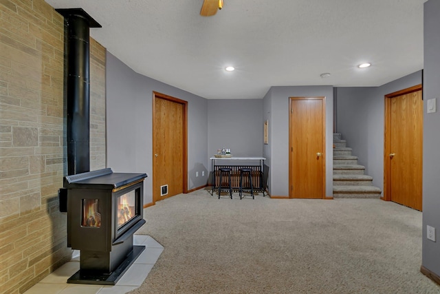 1506 6th Ave N, Sartell, MN 56377 - basement featuring a wood stove, carpet flooring, baseboards, stairway, and recessed lighting