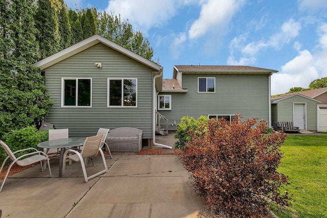 1506 6th Ave N, Sartell, MN 56377 - back of house featuring a patio area and a lawn