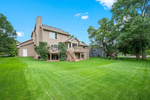 8909 Vickors Xing, Brooklyn Park, MN 55443 - back of house with stairway, a deck, a chimney, and a yard