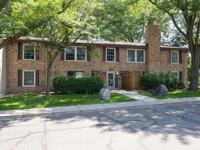 4600 Cedar Lake Rd S Unit 6, Saint Louis Park, MN 55416 - colonial house featuring a chimney and brick siding