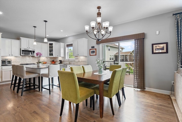 11444 Creekside Ct, Rogers, MN 55311 - dining room with dark wood-type flooring, a chandelier, baseboards, and recessed lighting