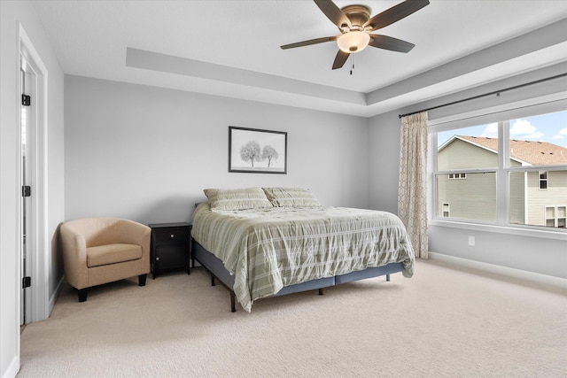 11444 Creekside Ct, Rogers, MN 55311 - bedroom featuring light carpet, baseboards, a raised ceiling, and a ceiling fan