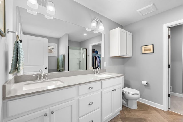11444 Creekside Ct, Rogers, MN 55311 - bathroom with a shower stall, double vanity, a spacious closet, toilet, and baseboards