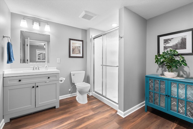 11444 Creekside Ct, Rogers, MN 55311 - bathroom featuring toilet, baseboards, a shower stall, vanity, and a textured ceiling
