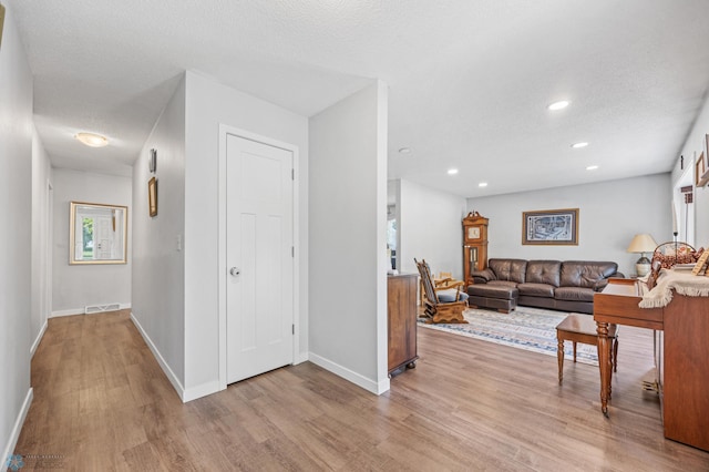 1311 Joseph St, Hawley, MN 56549 - living area featuring wood finished floors, baseboards, recessed lighting, and a textured ceiling