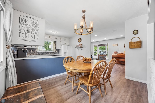 1311 Joseph St, Hawley, MN 56549 - dining area with light wood-style floors, a chandelier, recessed lighting, and baseboards