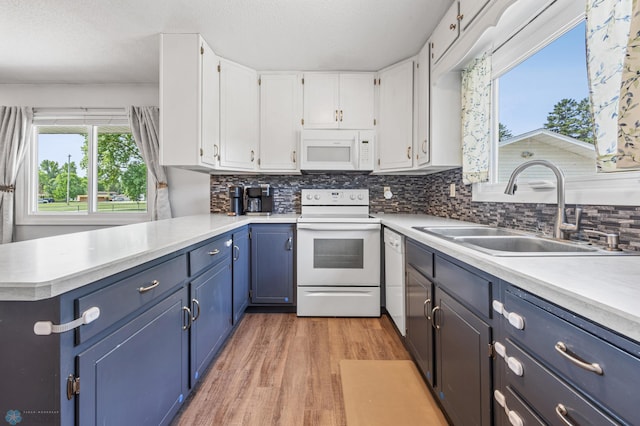 1311 Joseph St, Hawley, MN 56549 - kitchen featuring white appliances, a sink, white cabinets, light wood finished floors, and blue cabinets