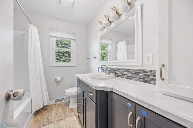 1311 Joseph St, Hawley, MN 56549 - bathroom featuring vanity, toilet, baseboards, tasteful backsplash, and shower / bath combo