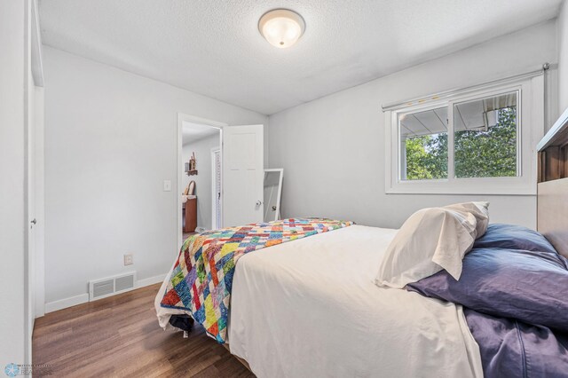 1311 Joseph St, Hawley, MN 56549 - bedroom featuring wood finished floors, baseboards, and a textured ceiling