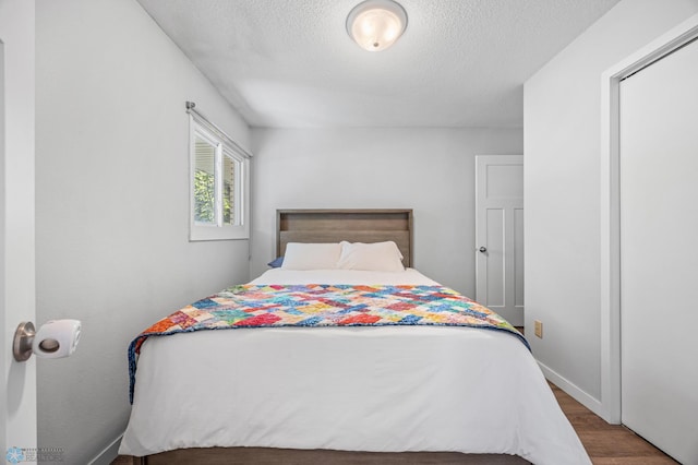 1311 Joseph St, Hawley, MN 56549 - bedroom featuring wood finished floors, a textured ceiling, and baseboards