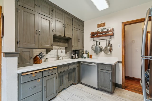 5705 36th Ave S, Minneapolis, MN 55417 - kitchen with stainless steel appliances, decorative backsplash, light countertops, gray cabinets, and light wood-style floors
