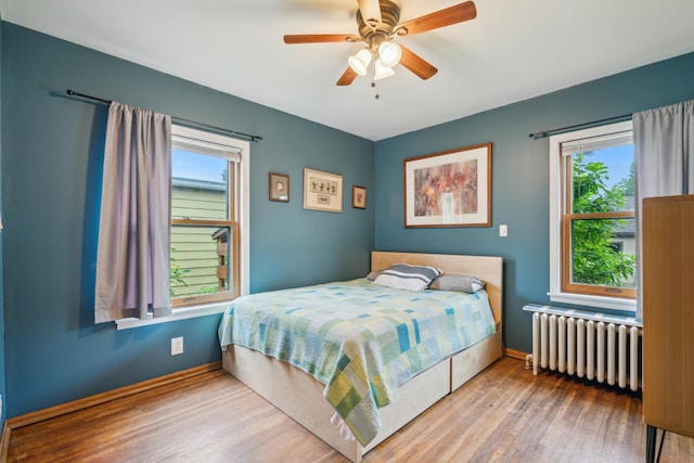 5705 36th Ave S, Minneapolis, MN 55417 - bedroom with radiator, multiple windows, wood finished floors, and ceiling fan