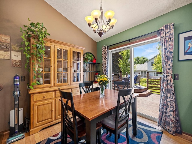 201 3rd St NW, Saint Michael, MN 55376 - dining space with vaulted ceiling, light wood-style floors, and a chandelier