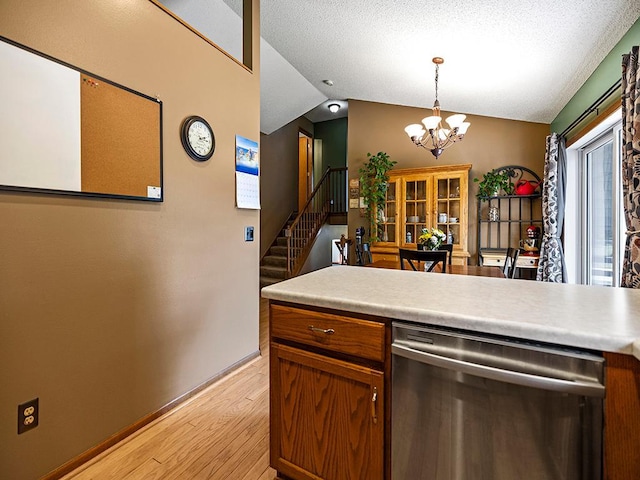 201 3rd St NW, Saint Michael, MN 55376 - kitchen featuring stainless steel dishwasher, light wood-style floors, a chandelier, lofted ceiling, and light countertops