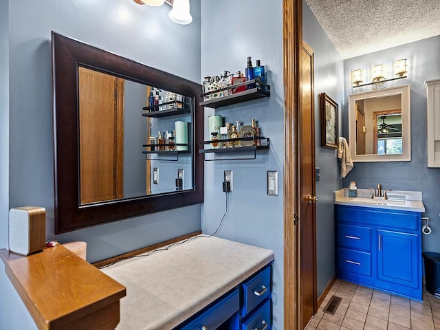 201 3rd St NW, Saint Michael, MN 55376 - bathroom featuring vanity, tile patterned flooring, and a textured ceiling