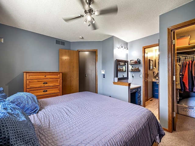 201 3rd St NW, Saint Michael, MN 55376 - bedroom featuring a spacious closet, a closet, light colored carpet, a ceiling fan, and connected bathroom