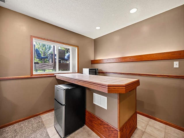 201 3rd St NW, Saint Michael, MN 55376 - kitchen featuring refrigerator, tile counters, a peninsula, a textured ceiling, and recessed lighting