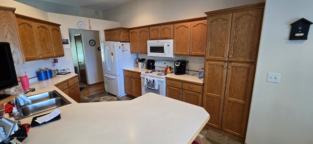 4708 21st St N, Moorhead, MN 56560 - kitchen featuring white appliances, a sink, light countertops, and brown cabinets