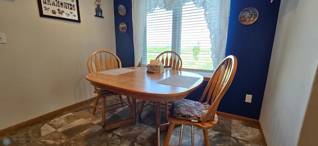 4708 21st St N, Moorhead, MN 56560 - dining area featuring baseboards and stone finish floors