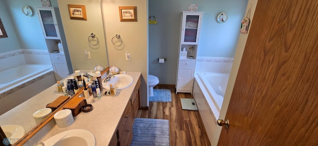4708 21st St N, Moorhead, MN 56560 - full bath featuring a bath, wood finished floors, double vanity, and toilet
