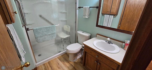 4708 21st St N, Moorhead, MN 56560 - full bathroom with a shower stall, wood finished floors, toilet, and vanity