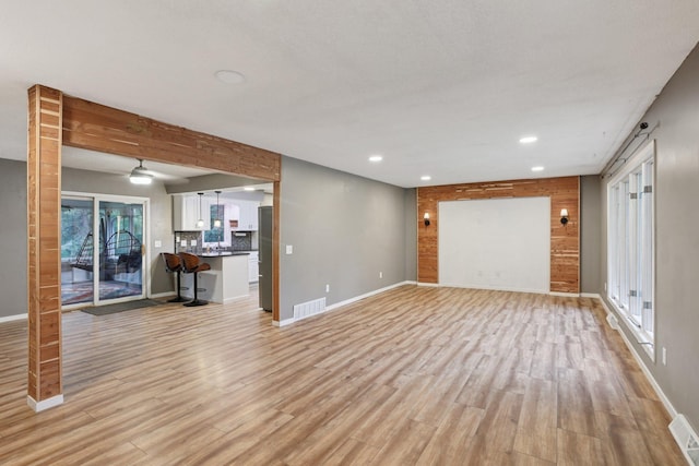 1985 Mabel Ct, Chaska, MN 55318 - unfurnished living room with light wood-type flooring, recessed lighting, and plenty of natural light