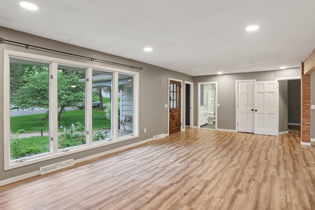 1985 Mabel Ct, Chaska, MN 55318 - unfurnished living room featuring healthy amount of natural light, light wood-style floors, and recessed lighting