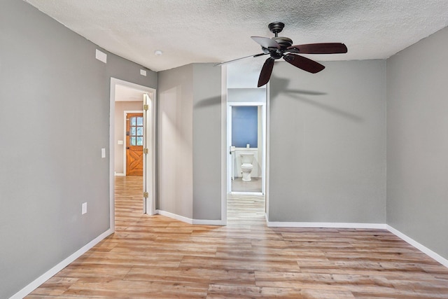 1985 Mabel Ct, Chaska, MN 55318 - empty room with light wood-type flooring, ceiling fan, and a textured ceiling