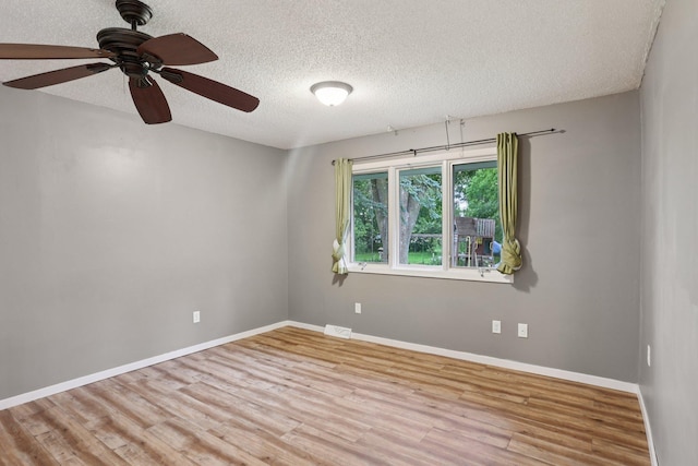 1985 Mabel Ct, Chaska, MN 55318 - unfurnished room with a textured ceiling, wood finished floors, and a ceiling fan