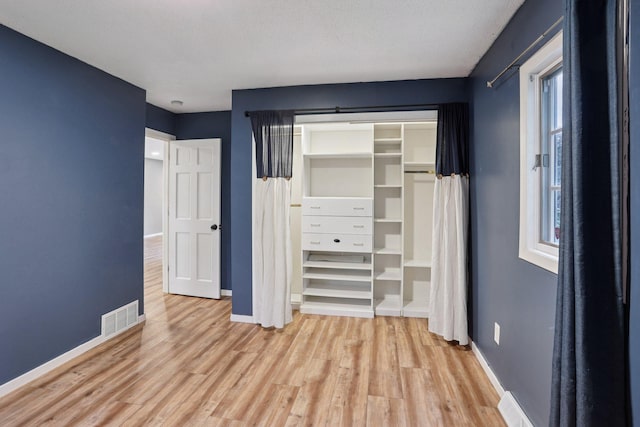 1985 Mabel Ct, Chaska, MN 55318 - unfurnished bedroom with light wood-type flooring and a closet