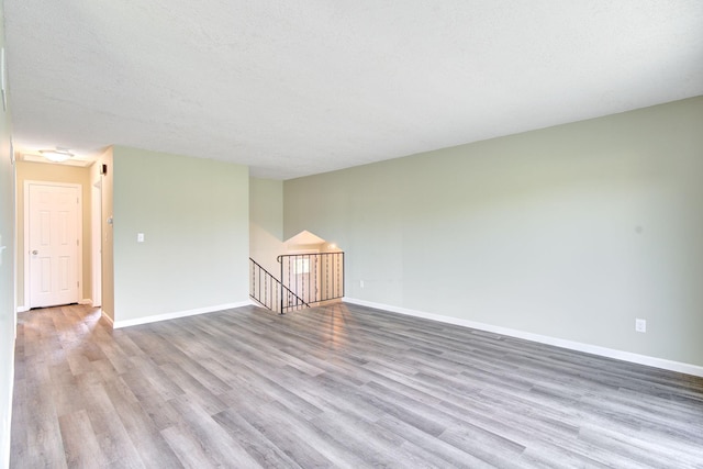 1414 5th Ave SW, Rochester, MN 55902 - empty room featuring wood finished floors and baseboards