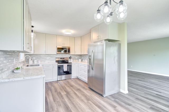 1414 5th Ave SW, Rochester, MN 55902 - kitchen featuring appliances with stainless steel finishes, a sink, light wood-type flooring, backsplash, and baseboards