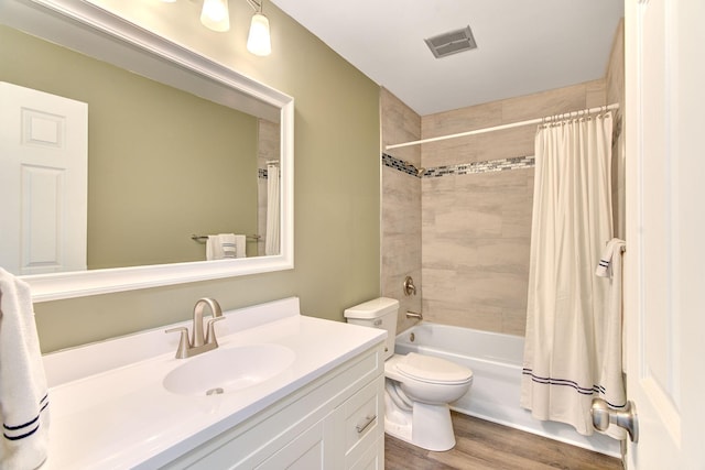 1414 5th Ave SW, Rochester, MN 55902 - bathroom featuring vanity, wood finished floors, toilet, and shower / tub combo