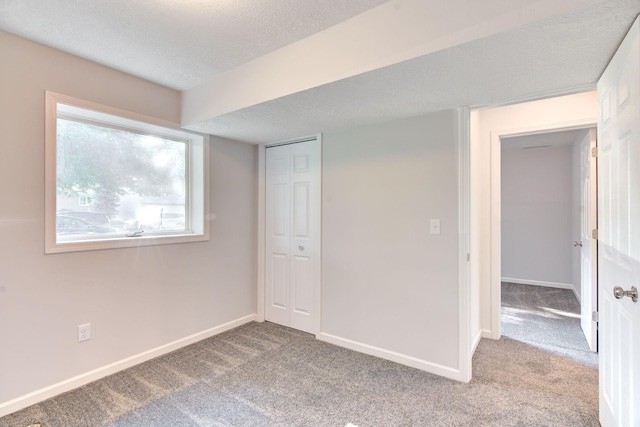 1414 5th Ave SW, Rochester, MN 55902 - unfurnished bedroom featuring carpet, a textured ceiling, baseboards, and a closet