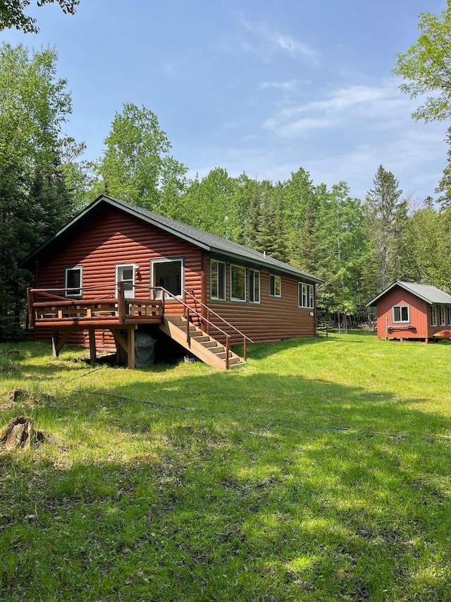 1760 Grindstone Is, International Falls, MN 56649 - back of property with a wooden deck, a yard, and an outdoor structure