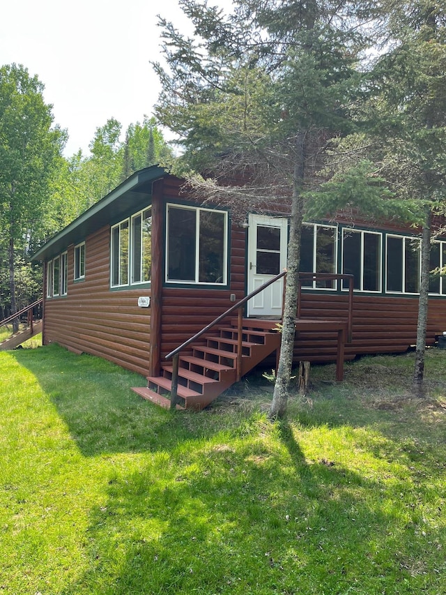 1760 Grindstone Is, International Falls, MN 56649 - back of house with log veneer siding and a lawn