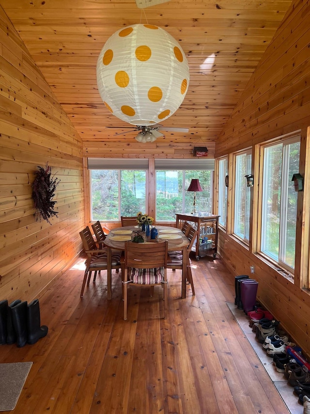 1760 Grindstone Is, International Falls, MN 56649 - dining area with vaulted ceiling, wood-type flooring, wood ceiling, wood walls, and ceiling fan