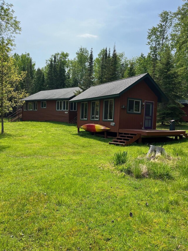 1760 Grindstone Is, International Falls, MN 56649 - rear view of house featuring a wooden deck and a yard