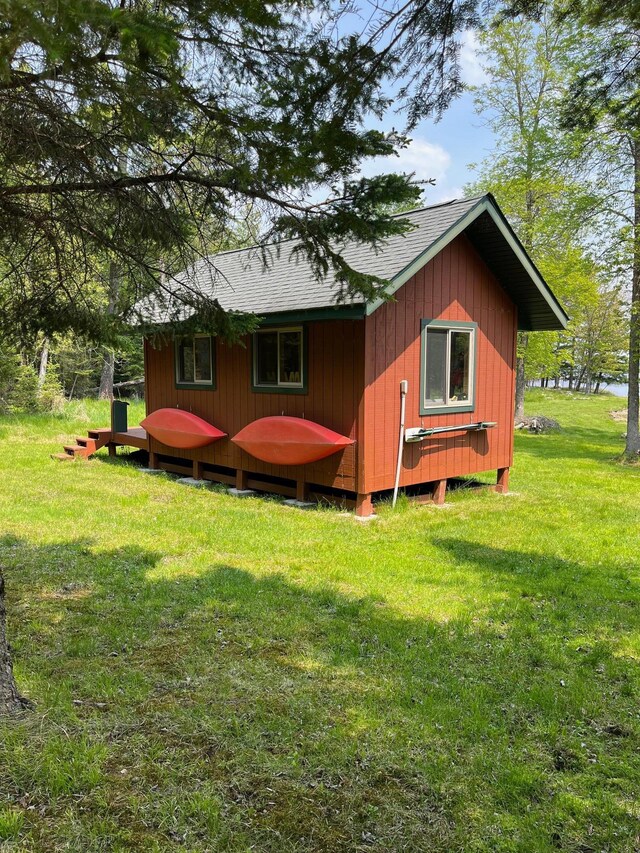 1760 Grindstone Is, International Falls, MN 56649 - view of side of home with a shingled roof and a yard