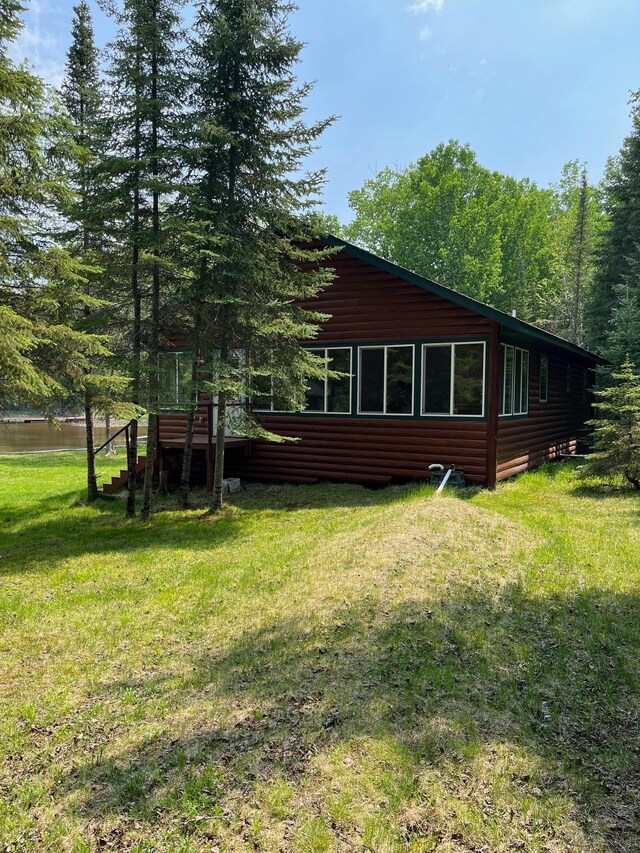 1760 Grindstone Is, International Falls, MN 56649 - view of side of home featuring faux log siding and a lawn