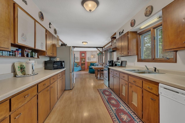 3566 State Highway 210, Baxter, MN 56425 - kitchen with white dishwasher, stainless steel range with electric cooktop, a sink, light countertops, and a textured ceiling