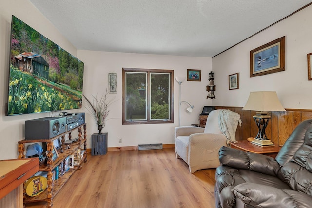 3566 State Highway 210, Baxter, MN 56425 - living room with light wood-style flooring, a textured ceiling, and baseboards