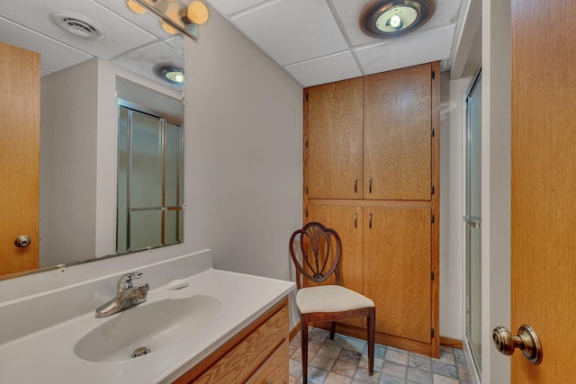 3566 State Highway 210, Baxter, MN 56425 - bathroom featuring vanity, a shower with door, a paneled ceiling, and baseboards