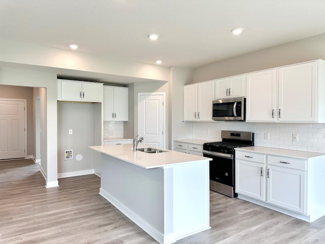 222 Snowdrop Trl, Waconia, MN 55387 - kitchen with appliances with stainless steel finishes, light wood-style floors, light countertops, white cabinetry, and recessed lighting
