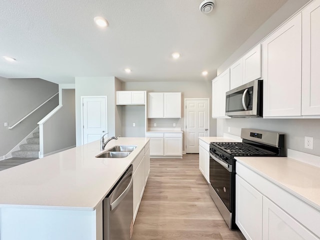 151 Snowdrop Trl, Waconia, MN 55387 - kitchen with appliances with stainless steel finishes, light wood-style floors, white cabinetry, light countertops, and recessed lighting