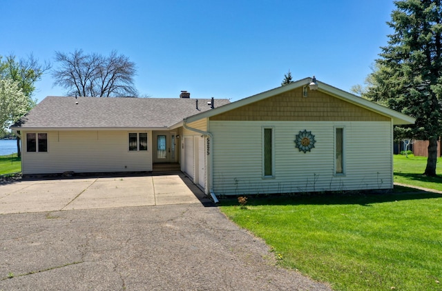 5225 217th St N, Forest Lake, MN 55025 - view of front of house featuring a garage, driveway, a front yard, and a shingled roof